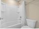 Clean bathroom features a shower and tub combination with a white curtain at 3659 White Wing Circle, Myrtle Beach, SC 29579