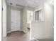 Bright hallway with wood-look floors, neutral walls, and bathroom access at 3659 White Wing Circle, Myrtle Beach, SC 29579