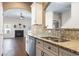 Gourmet kitchen featuring granite countertops, stainless steel appliances, and seamless flow to the living room at 3659 White Wing Circle, Myrtle Beach, SC 29579