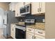 This contemporary kitchen offers stainless steel appliances and stylish, geometric backsplash at 3659 White Wing Circle, Myrtle Beach, SC 29579