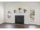 Cozy living room with a classic fireplace, neutral walls, and a door to the backyard at 3659 White Wing Circle, Myrtle Beach, SC 29579
