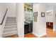 Stylish staircase with a sleek built-in bar area featuring glass shelves and ample storage at 381 Da Gullah Way # 8 B, Pawleys Island, SC 29585