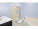 Bathroom featuring a glass shower, jacuzzi tub, white walls and vanity top, and neutral flooring at 381 Da Gullah Way # 8 B, Pawleys Island, SC 29585