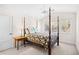 Bright bedroom featuring a four-poster bed, neutral walls and carpet, and a light-colored ceiling fan at 381 Da Gullah Way # 8 B, Pawleys Island, SC 29585