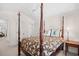 Bright bedroom featuring a four-poster bed, neutral walls and carpet, and a light-colored ceiling fan at 381 Da Gullah Way # 8 B, Pawleys Island, SC 29585