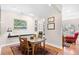 Warm dining room with rustic wooden table and chairs, adjacent to the cozy living area at 381 Da Gullah Way # 8 B, Pawleys Island, SC 29585