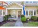 Inviting front porch with bench, manicured landscaping, and charming South Carolina flag at 381 Da Gullah Way # 8 B, Pawleys Island, SC 29585