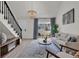 A well-lit living room featuring a stair case, sliding glass door, and modern decor at 400 Cambridge Circle # L-7, Murrells Inlet, SC 29576