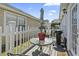 The back patio features a glass-topped table with seating and a grill, perfect for outdoor entertaining at 413 Chesterfield Ct., Myrtle Beach, SC 29577