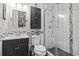 Modern bathroom features stylish black vanity with sink and a glass enclosed shower with white marble-style tiling at 413 Chesterfield Ct., Myrtle Beach, SC 29577