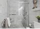 Elegant bathroom features white marble-style tiling and a modern glass shower with polished chrome fixtures at 413 Chesterfield Ct., Myrtle Beach, SC 29577