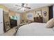 Cozy bedroom featuring a ceiling fan, full-length mirror, dresser, and television over an electric fireplace at 413 Chesterfield Ct., Myrtle Beach, SC 29577