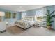 Serene bedroom with blue walls, plush bedding, ample natural light, and views of the surrounding landscape at 414 Acosta Circle, Conway, SC 29527