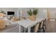 Open dining area with a white table and black woven chairs connecting seamlessly to the bright living room at 414 Acosta Circle, Conway, SC 29527