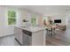 Open-concept kitchen featuring a large island with seating, gray cabinets, and stainless steel dishwasher at 414 Acosta Circle, Conway, SC 29527
