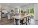 Modern kitchen with gray cabinets, stainless steel appliances, an island, and a dining area leading to the backyard at 414 Acosta Circle, Conway, SC 29527