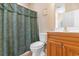 Bathroom featuring a toilet, shower with curtain, and a wooden vanity at 4141 Hibiscus Dr. # 201, Little River, SC 29566