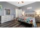 Bedroom features light gray walls, wood laminate flooring, ceiling fan, and vibrant bedding at 4141 Hibiscus Dr. # 201, Little River, SC 29566