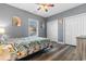 Bright bedroom featuring a double bed, two closets, hardwood floor, and a ceiling fan at 4141 Hibiscus Dr. # 201, Little River, SC 29566