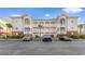 Condo building with ample parking, nicely landscaped, featuring private balconies and attractive architectural details at 4141 Hibiscus Dr. # 201, Little River, SC 29566