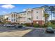 Condo building features ample parking, nicely landscaped grounds, private balconies and attractive architectural details at 4141 Hibiscus Dr. # 201, Little River, SC 29566