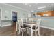 Eat-in kitchen with wooden table, chairs, and bar seating, next to a room with a bunk bed at 4141 Hibiscus Dr. # 201, Little River, SC 29566