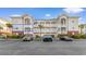 Condo complex featuring covered balconies and well-manicured landscaping and parking at 4141 Hibiscus Dr. # 201, Little River, SC 29566
