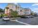 Beautiful condo complex featuring parking, tropical landscaping, and building with exterior stairwells at 4141 Hibiscus Dr. # 201, Little River, SC 29566