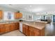 Open kitchen featuring wooden cabinets, stainless sink, and view to the living room at 4141 Hibiscus Dr. # 201, Little River, SC 29566