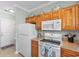 Bright kitchen area featuring wooden cabinets and modern appliances at 4141 Hibiscus Dr. # 201, Little River, SC 29566