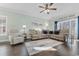 Spacious living room with a beige sectional sofa, area rug, ceiling fan and natural light at 4141 Hibiscus Dr. # 201, Little River, SC 29566