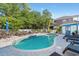 Inviting pool area with lounge chairs, umbrellas, and mature landscaping for a relaxing experience at 4141 Hibiscus Dr. # 201, Little River, SC 29566