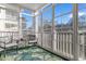 Bright sunroom filled with windows and greenery-themed decor and seating at 4141 Hibiscus Dr. # 201, Little River, SC 29566