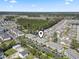 Aerial view of the community highlighting its location near lush forest and neighborhood of single-Gathering homes at 4155 Hibiscus Dr. # 204, Little River, SC 29566