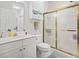 Clean bathroom featuring a vanity with storage, a toilet, and a shower at 4155 Hibiscus Dr. # 204, Little River, SC 29566