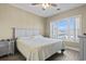 Cozy bedroom features a comfortable bed, a large window providing natural light, and hardwood floors at 4155 Hibiscus Dr. # 204, Little River, SC 29566