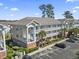 Exterior view of the building, showcasing multiple floors, balconies, and convenient parking at 4155 Hibiscus Dr. # 204, Little River, SC 29566