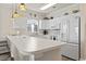 Well-lit kitchen featuring white cabinets, modern appliances, and a breakfast bar at 4155 Hibiscus Dr. # 204, Little River, SC 29566