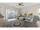 Bright living room with stylish furnishings, ceiling fan, and sliding glass doors to the outside patio at 4155 Hibiscus Dr. # 204, Little River, SC 29566
