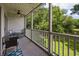 Balcony featuring outdoor chairs and a table, and a scenic view of the pond and trees at 45 Pinehurst Ln. # 2G, Pawleys Island, SC 29585