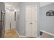 Hallway with white doors, ceramic tile, and walls with a light-gray finish at 45 Pinehurst Ln. # 2G, Pawleys Island, SC 29585