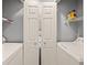 Bright laundry room featuring a white washer and dryer with shelving for storage at 45 Pinehurst Ln. # 2G, Pawleys Island, SC 29585