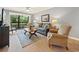 Relaxing living room featuring a cozy couch, natural light from the glass sliding door, and stylish decor at 45 Pinehurst Ln. # 2G, Pawleys Island, SC 29585