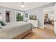 Bright main bedroom features a ceiling fan, TV, access to balcony, and an ensuite bathroom at 45 Pinehurst Ln. # 2G, Pawleys Island, SC 29585