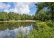 Scenic water view of a pond featuring trees and reflections of the sky and surrounding landscape at 45 Pinehurst Ln. # 2G, Pawleys Island, SC 29585