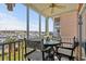 Cozy balcony features a table and chairs overlooking the picturesque marina view at 4633 Lightkeepers Way # 5H, Little River, SC 29566