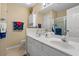 Well-lit bathroom with double sinks, ample storage, and nautical-themed accents for a fresh look at 4633 Lightkeepers Way # 5H, Little River, SC 29566