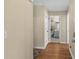 Inviting hallway featuring wood floors leading to bathroom and other rooms at 4633 Lightkeepers Way # 5H, Little River, SC 29566