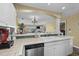 Well-lit kitchen featuring white cabinetry, stainless steel appliances, and breakfast bar at 4633 Lightkeepers Way # 5H, Little River, SC 29566