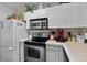 This kitchen boasts white cabinets, stainless appliances and modern countertops at 4633 Lightkeepers Way # 5H, Little River, SC 29566